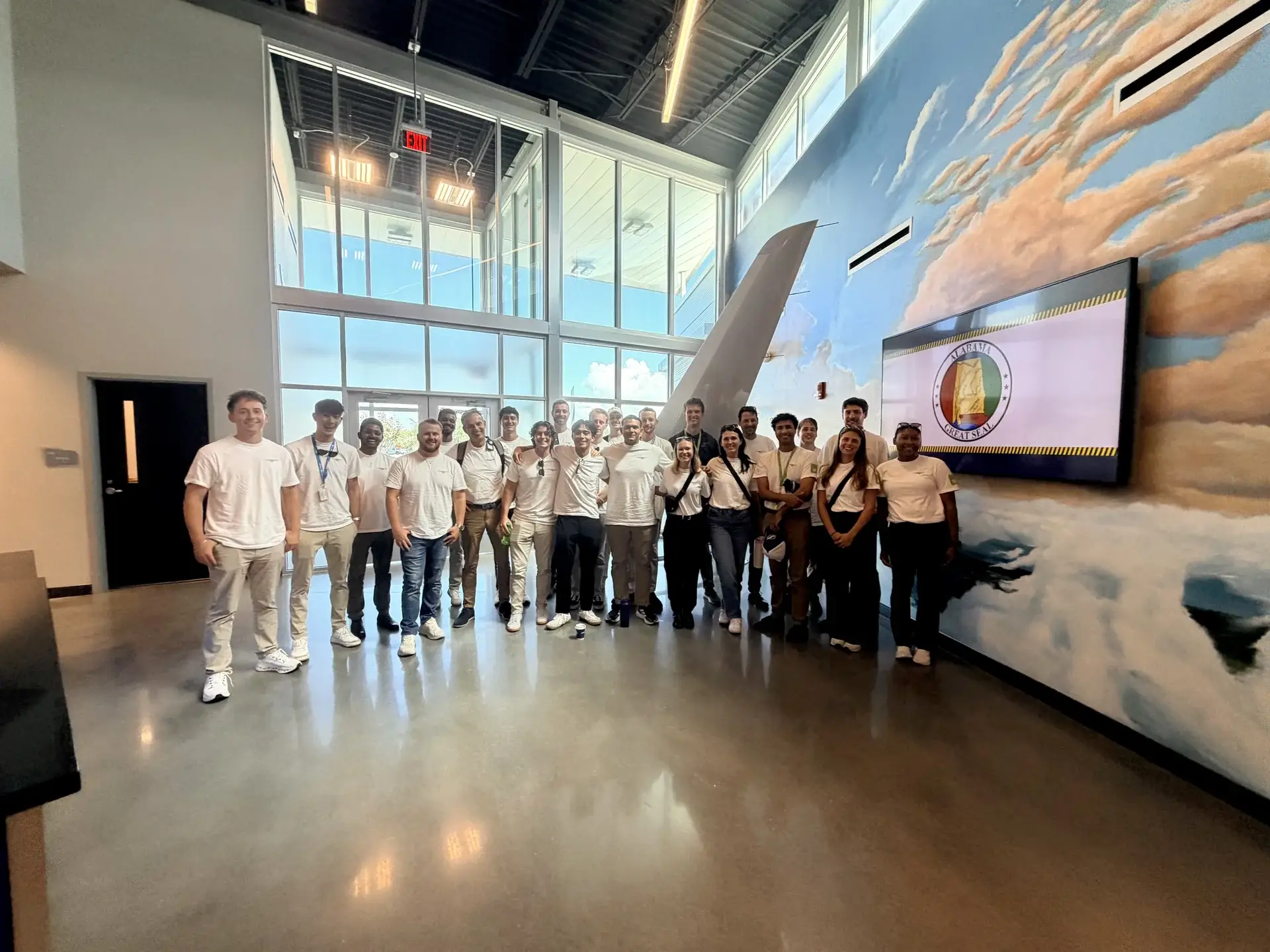Cirrus Aviation students and instructors standing together in the Flight Works Alabama lobby in Mobile