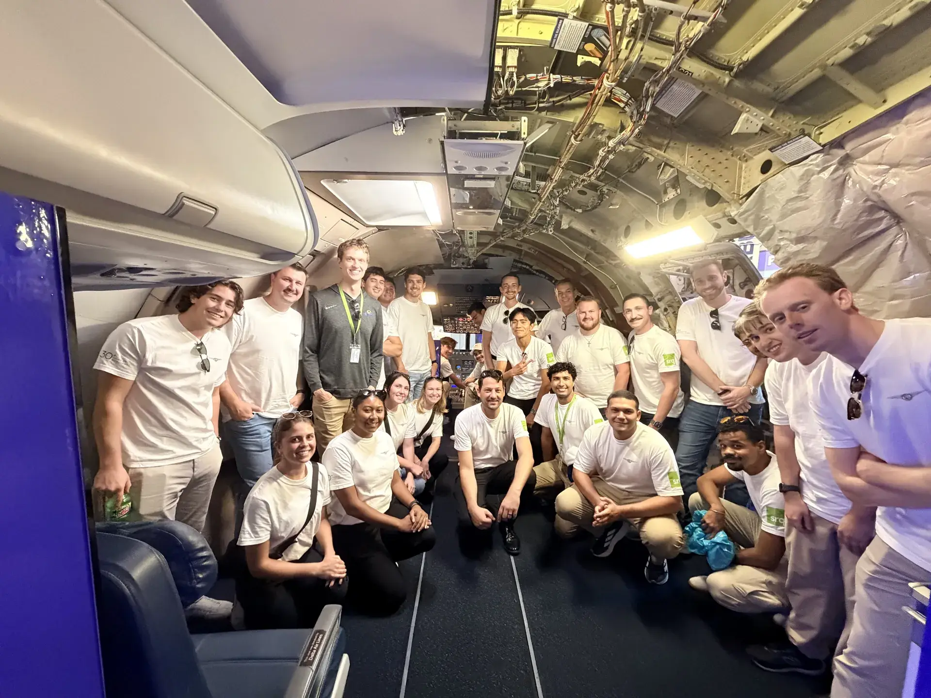 Cirrus Aviation students and instructors inside the airliner cabin exhibit at Flight Works Alabama