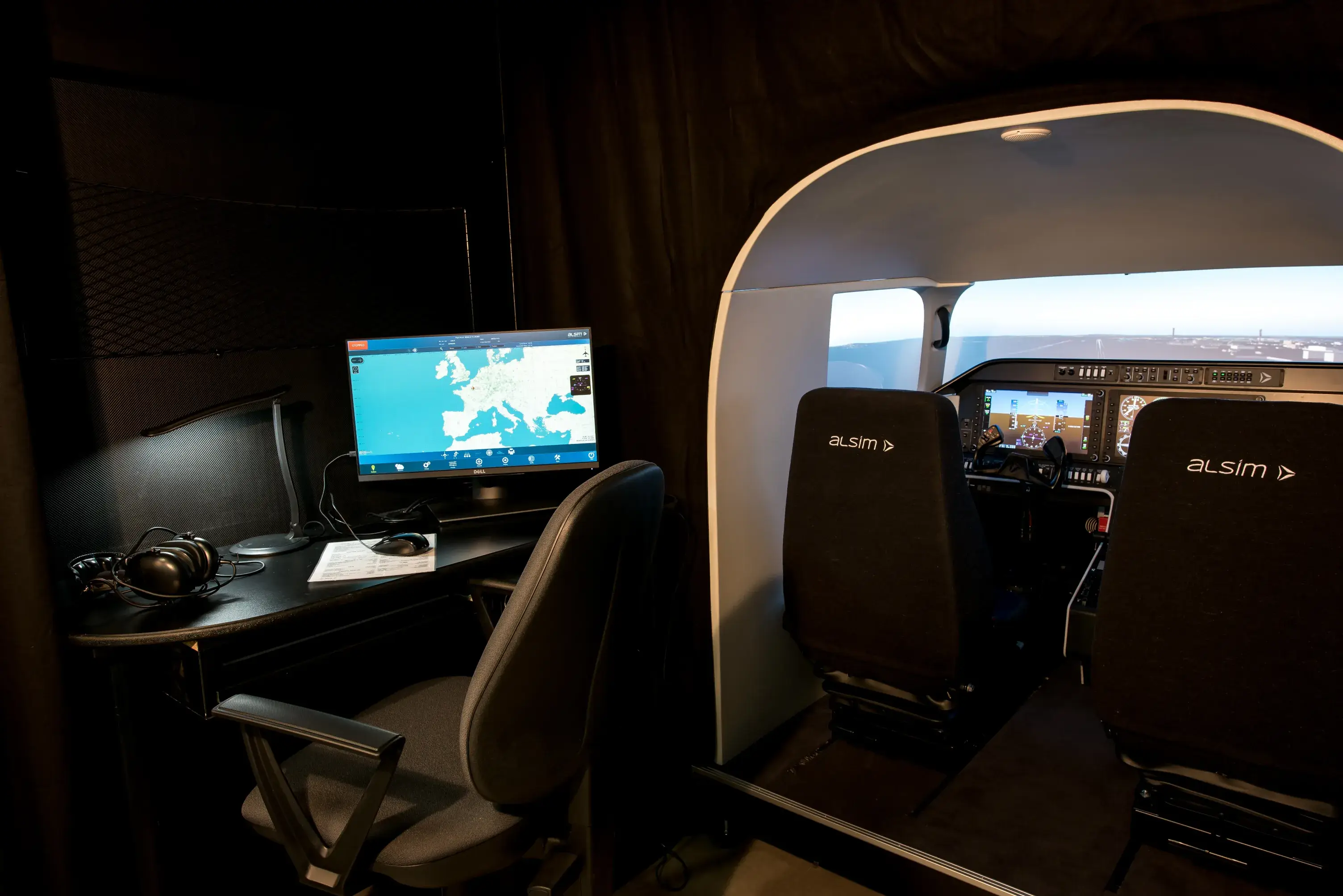 Alsim simulator cockpit with the instructor station beside it at Cirrus Aviation
