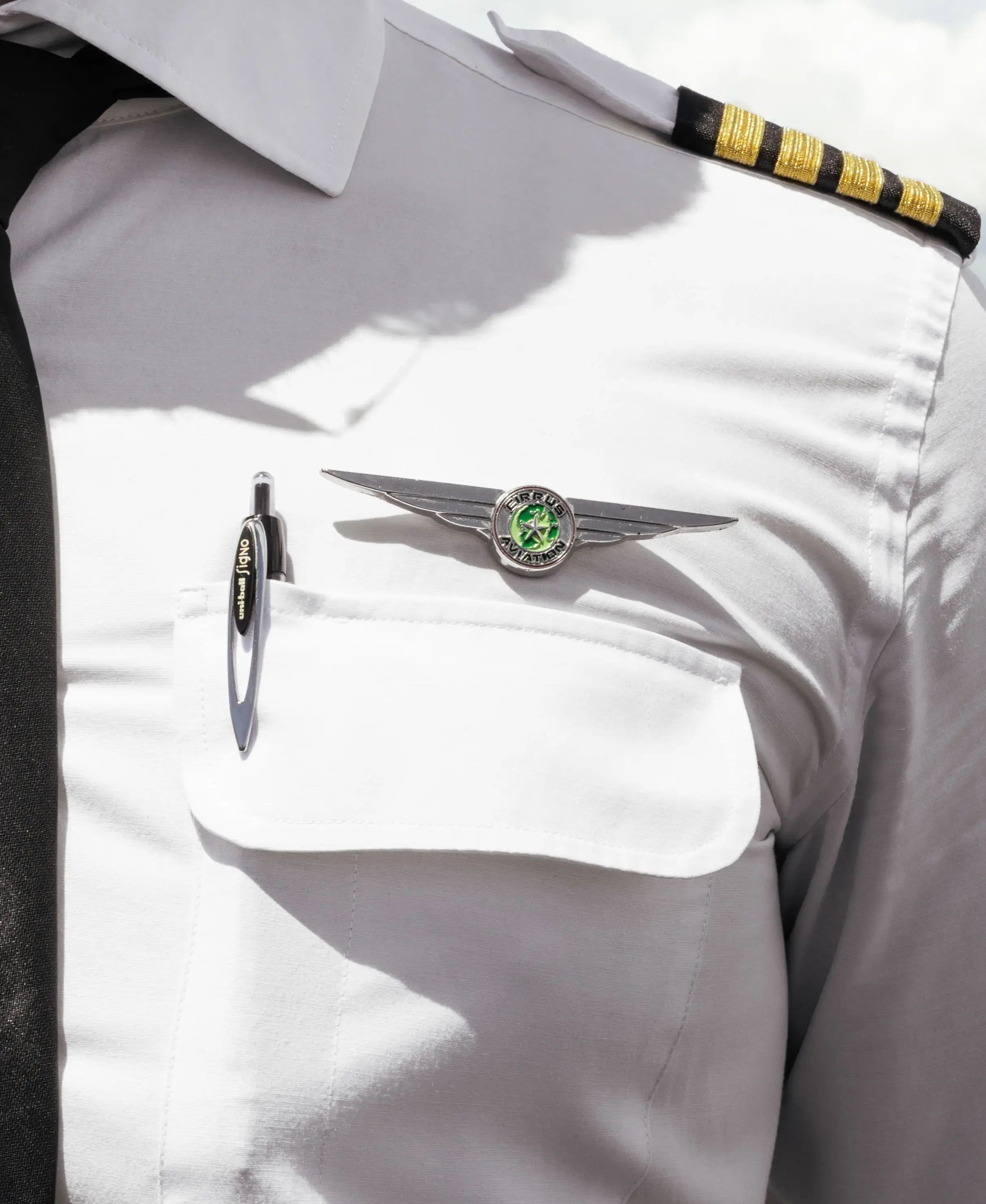 Pilot uniform shirt with Cirrus Aviation wings and captain epaulettes