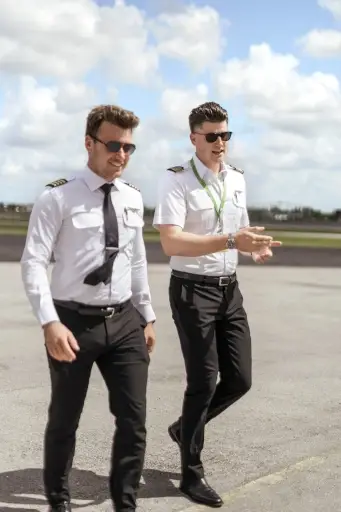 Two pilots walking on the runway