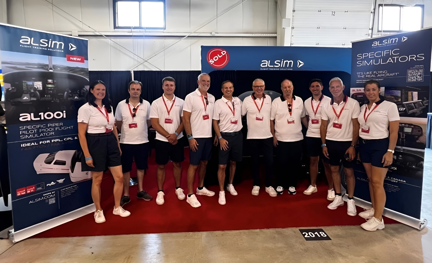 Alsim stand with people in a semi-circle in uniform at EAA AirVenture Oshkosh 2024