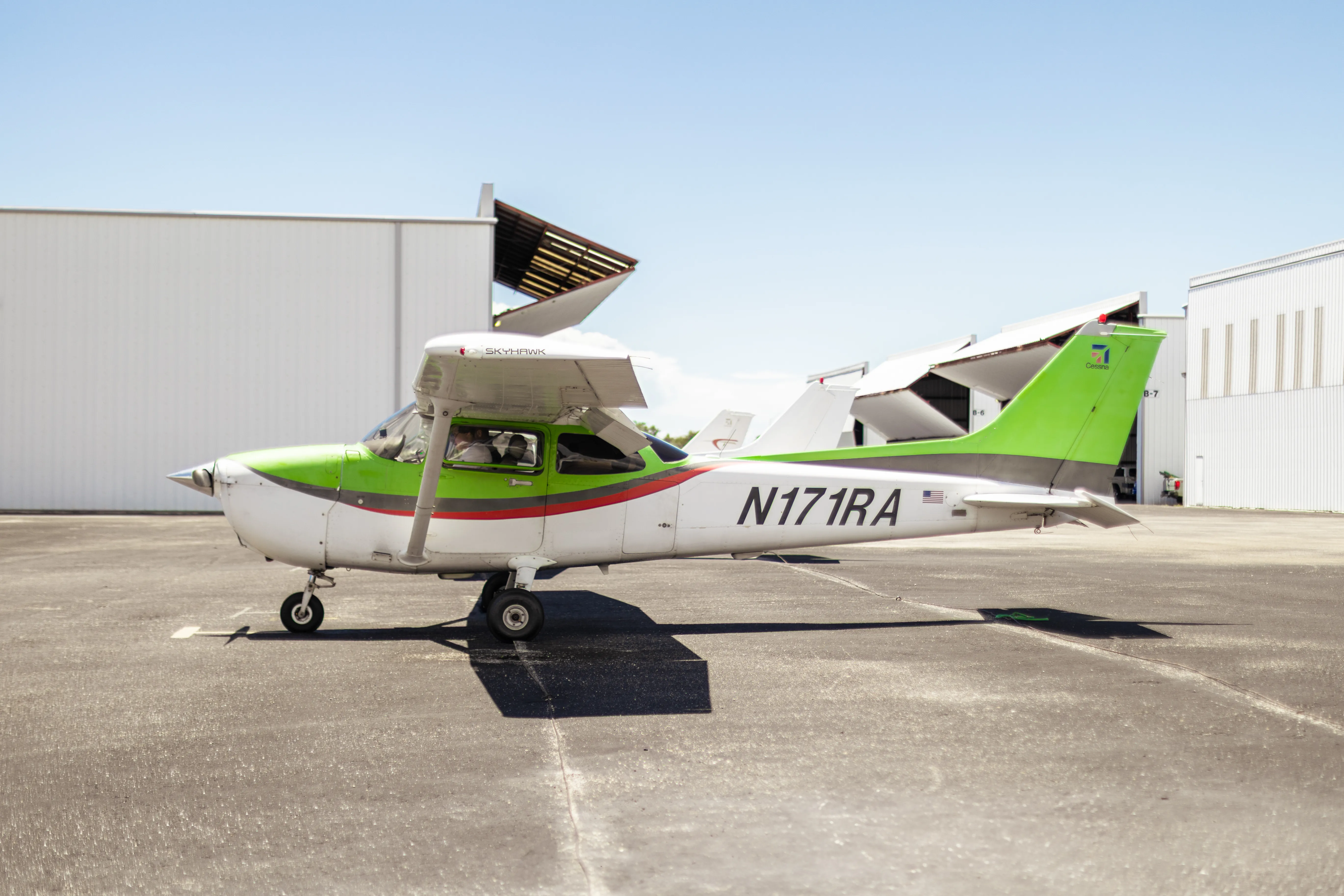 Cessna 172 Skyhawk N171RA parked on the Cirrus Aviation ramp at KSRQ