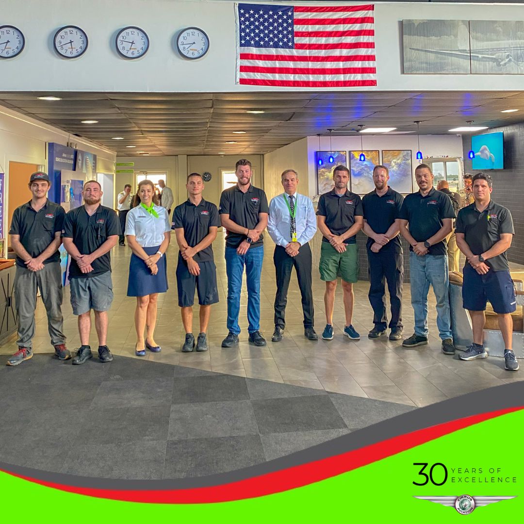 Cirrus Aviation maintenance team standing together in the hangar at KSRQ