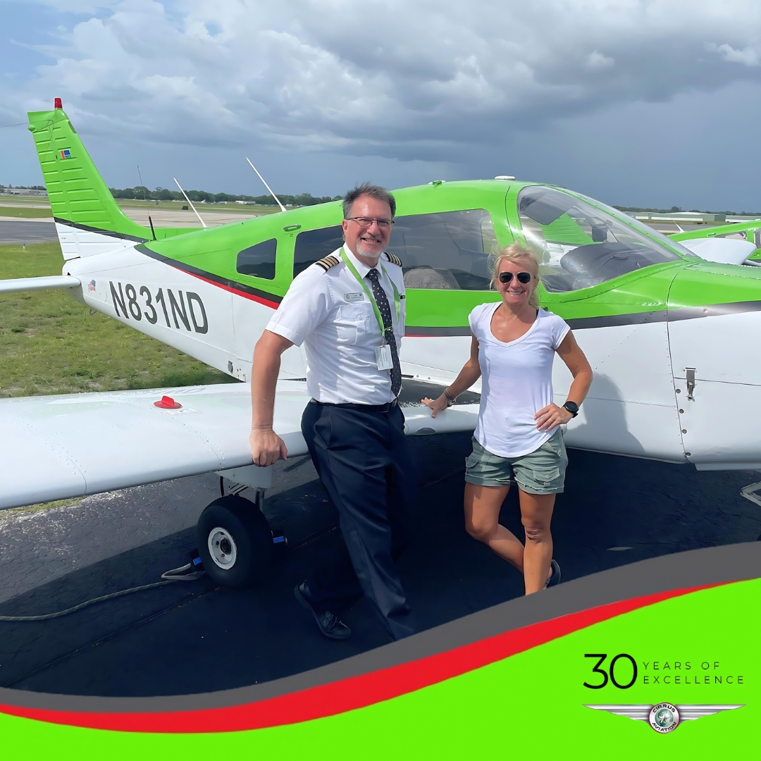 Student and CFI standing in front of Piper Warrior aircraft, Cirrus Aviation watermark at the bottom of the image