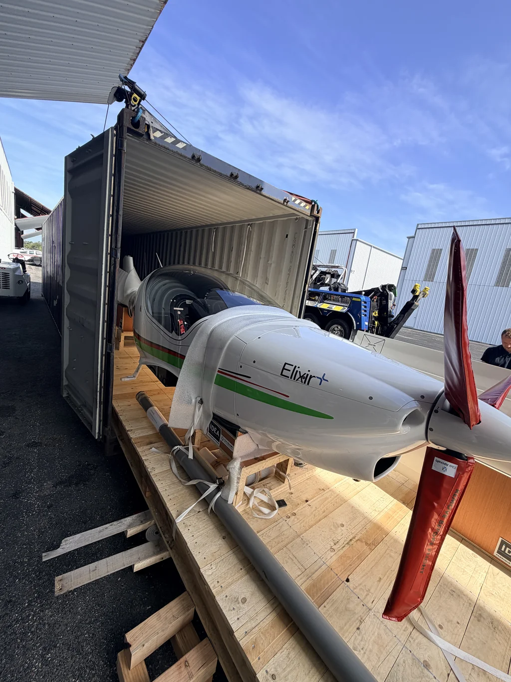 Elixir aircraft being unloaded from a shipping container after arriving in Sarasota