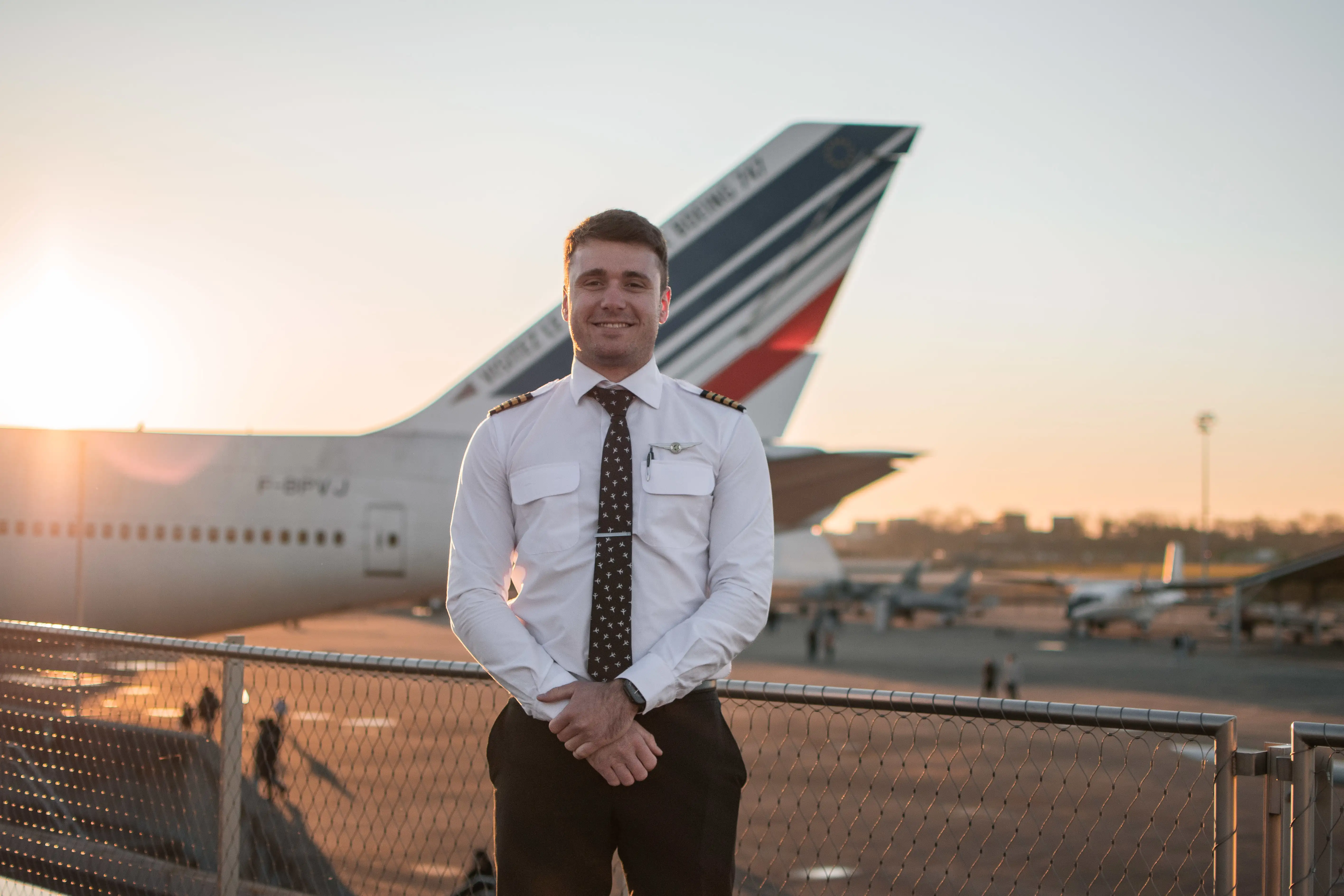 Adult pilot standing in front of an airplane before a flight