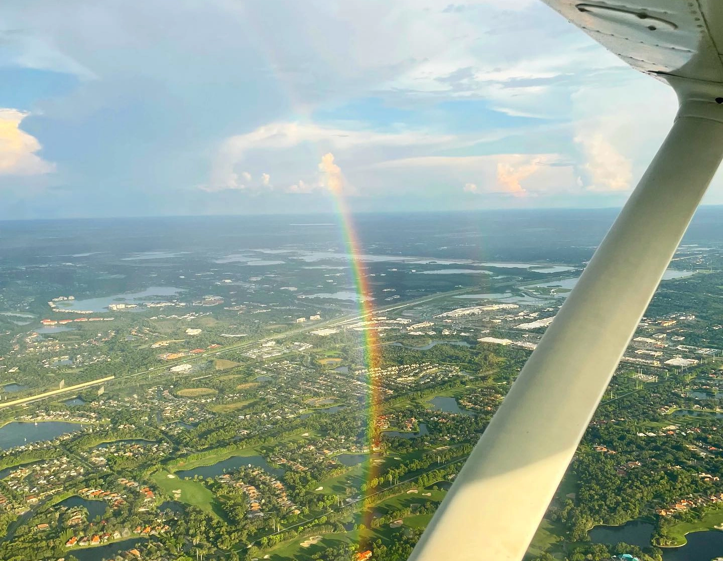 Rainbow viewed from an airplane during a flight over Tampa Bay